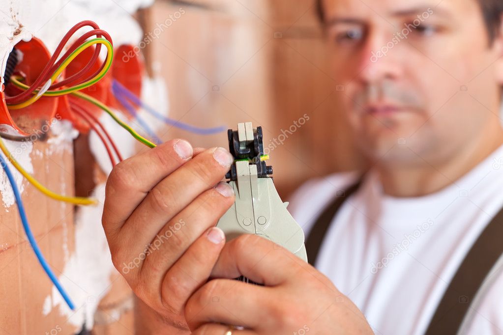 Handyman working on a light fixture safely