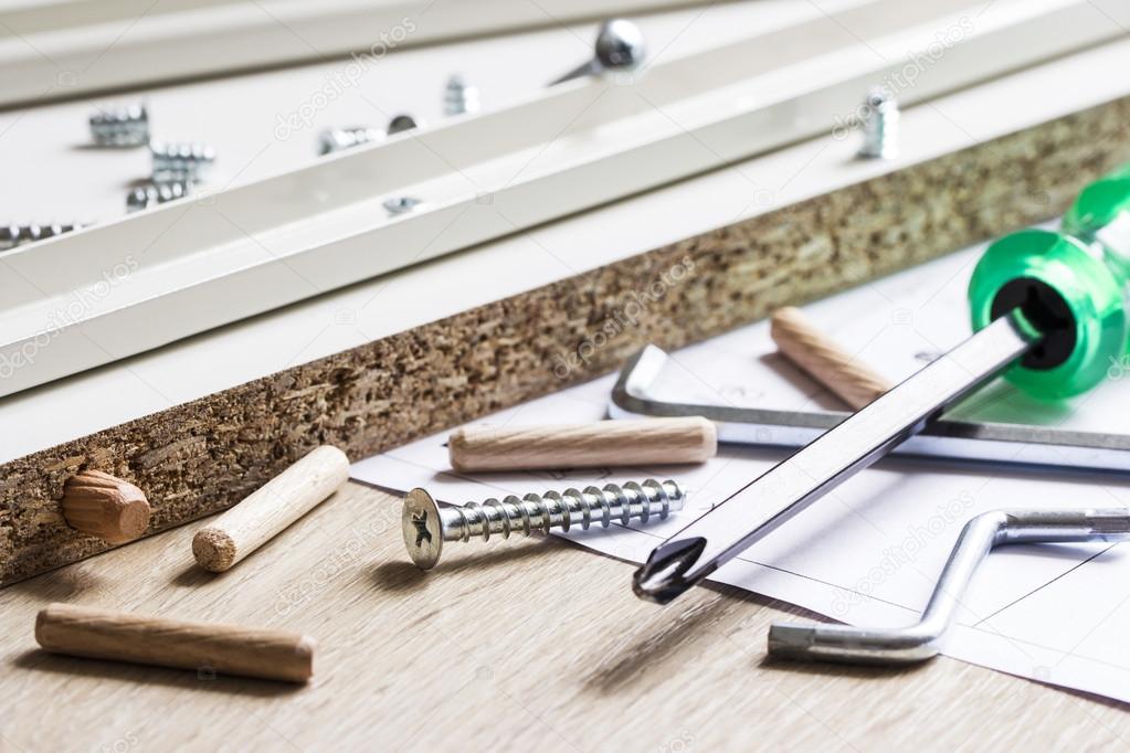 Handyman assembling flat-pack furniture in a home