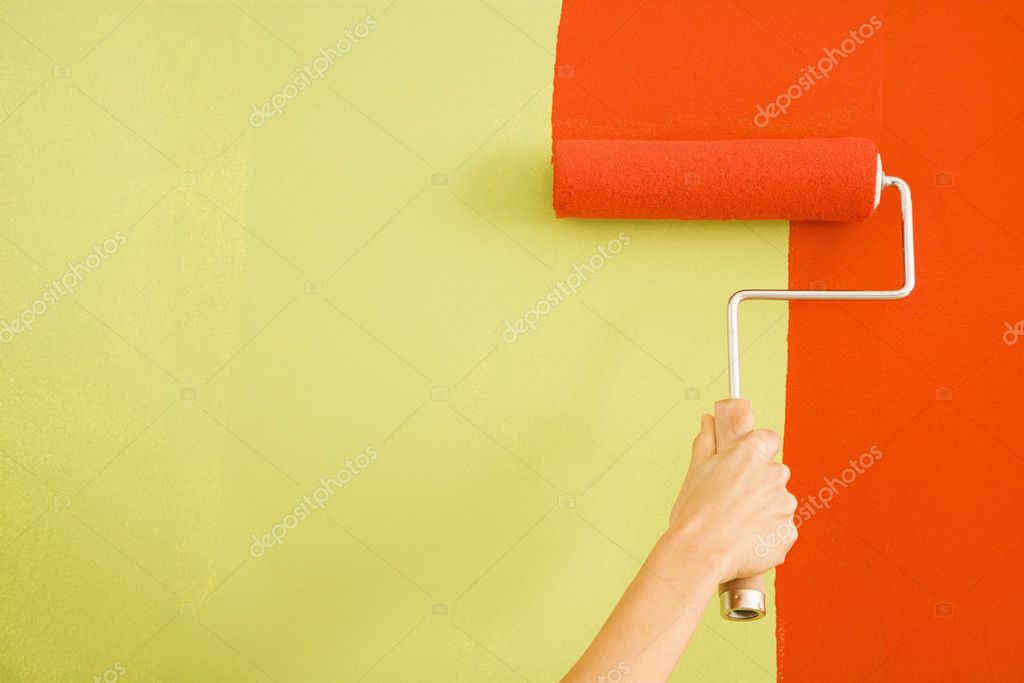 Fresh paint being rolled onto a living room wall