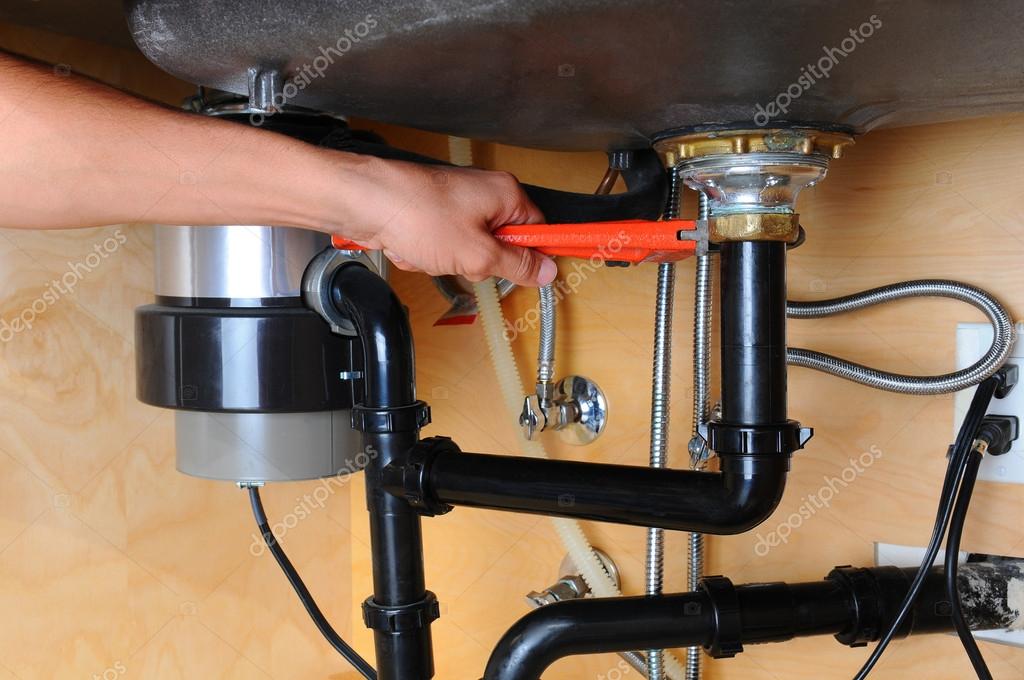 Under-sink plumbing repaired and organized